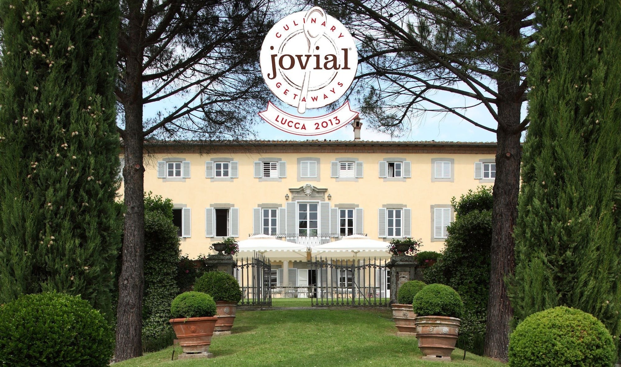 Jovial logo reading CULINARY GETAWAYS jovial LUCCA 2013 over a yellow Italian villa framed by cypress trees
