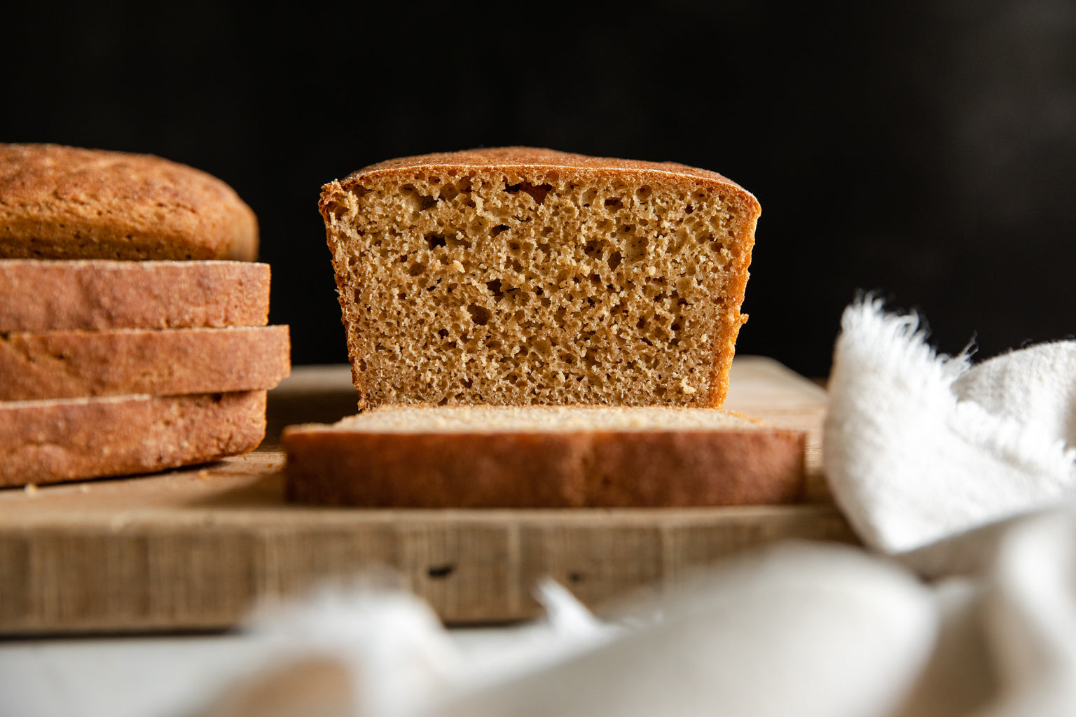 Whole Grain Einkorn Sandwich Loaf on a cutting board, sliced intoEasy 100% Whole Grain Einkorn Bread
