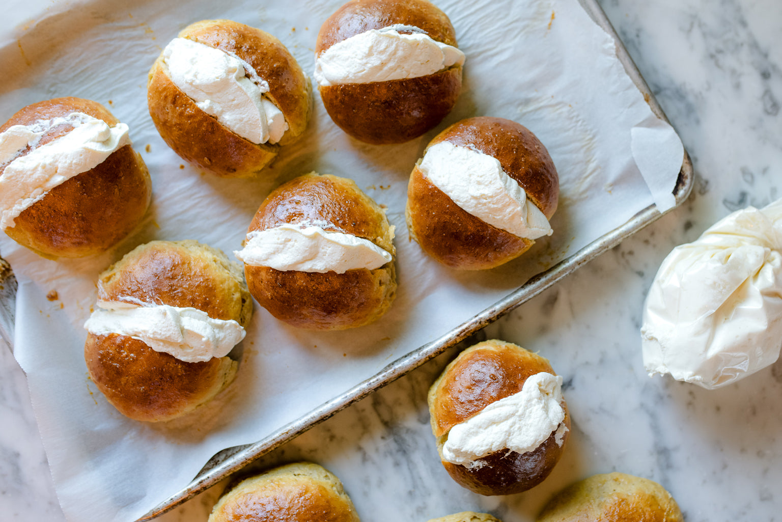 Einkorn Maritozzi on a baking sheet
