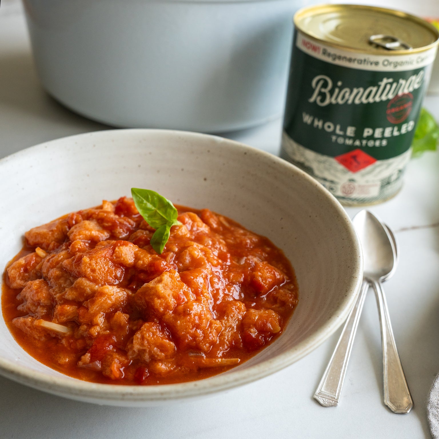 Pappa al pomodoro (bread cubes in tomato soup) with a few basil leaves, made with Bionaturae Whole Peeled Tomatoes